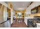 Open kitchen with stainless steel appliances, a dining area, and ample counter space, ideal for culinary enthusiasts at 2150 Maple Heights Ct, Henderson, NV 89052