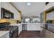 Modern kitchen equipped with stainless steel appliances, white cabinets, and dark wood floors, creating a sleek and functional space at 2150 Maple Heights Ct, Henderson, NV 89052