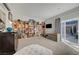 Large and open room features a TV and a slider to the backyard and pool at 2150 Maple Heights Ct, Henderson, NV 89052