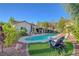 Beautiful backyard pool area with lounge chairs, landscaped yard, and inviting blue water, perfect for relaxation at 2150 Maple Heights Ct, Henderson, NV 89052