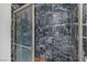 Modern walk-in shower featuring sleek black marble tile and a glass door at 2150 Maple Heights Ct, Henderson, NV 89052