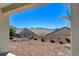 Desert landscaped backyard featuring rocks, shrubs, and fencing on a sunny day at 2508 Chasma Dr, Henderson, NV 89044
