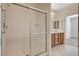 Bathroom featuring a glass shower enclosure, double vanity with wood cabinets at 2508 Chasma Dr, Henderson, NV 89044