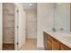 Bright bathroom with double vanity, toilet, walk in closet with shelving at 2508 Chasma Dr, Henderson, NV 89044