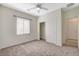 Bright bedroom featuring a ceiling fan, neutral carpet, closet, and a window bringing in natural light at 2508 Chasma Dr, Henderson, NV 89044
