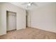 Bright carpeted bedroom with a fan, closet and a doorway, offering a cozy and functional space at 2508 Chasma Dr, Henderson, NV 89044