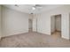 Neutral toned bedroom featuring two open doorways and a ceiling fan at 2508 Chasma Dr, Henderson, NV 89044