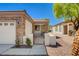 Welcoming home featuring a gated front entrance, stone accents, and a covered entryway at 2508 Chasma Dr, Henderson, NV 89044