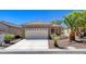 Charming single-story home with a stone facade, well-manicured landscaping, and a two-car garage at 2508 Chasma Dr, Henderson, NV 89044