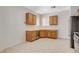 Kitchen featuring wooden cabinets, tile flooring and stainless steel dishwasher at 2508 Chasma Dr, Henderson, NV 89044