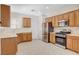 Bright kitchen features stainless steel appliances, wooden cabinets, and tile flooring at 2508 Chasma Dr, Henderson, NV 89044