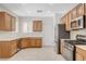 Well-lit kitchen featuring stainless steel appliances and tile flooring at 2508 Chasma Dr, Henderson, NV 89044