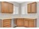 Bright kitchen with wooden cabinets, tile flooring, and a stainless steel dishwasher at 2508 Chasma Dr, Henderson, NV 89044