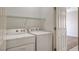 Laundry area featuring a washer and dryer, with doorway to carpeted room at 2508 Chasma Dr, Henderson, NV 89044