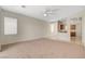 Spacious living room with neutral tones, a ceiling fan, and an open layout connecting to the kitchen at 2508 Chasma Dr, Henderson, NV 89044