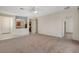 Bright living room featuring neutral carpet, a ceiling fan, and an open view of the kitchen at 2508 Chasma Dr, Henderson, NV 89044