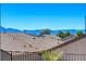 View of desert landscape with fenced yards and roofs of neighboring homes at 2508 Chasma Dr, Henderson, NV 89044