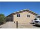 Side view of a desert home featuring gravel landscaping and a privacy fence at 2520 E Ambush St, Pahrump, NV 89048