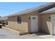 Desert home with tan stucco, gray roof, and entry door at 2520 E Ambush St, Pahrump, NV 89048