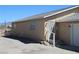 Desert home with tan stucco, gravel landscaping, and metal security door at 2520 E Ambush St, Pahrump, NV 89048