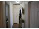 Hallway with decorative vases, wood-look flooring and white walls at 2520 E Ambush St, Pahrump, NV 89048