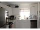 Bright modern kitchen with white cabinets and countertops, complete with stainless appliances at 2520 E Ambush St, Pahrump, NV 89048