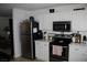 Modern kitchen with white cabinets, stainless steel appliances, and sleek countertops at 2520 E Ambush St, Pahrump, NV 89048