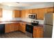 Updated kitchen featuring oak cabinetry, stainless steel appliances, and modern countertops at 2520 E Ambush St, Pahrump, NV 89048