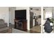 A cozy living room with a fireplace, mounted TV, and view into the kitchen at 2520 E Ambush St, Pahrump, NV 89048