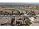 Community aerial view featuring well-manicured homes, lush landscaping, lake, and mountain views at 2585 Portsmouth Creek Ave, Henderson, NV 89052
