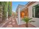 Picturesque backyard view featuring a covered patio, immaculate landscaping, and mature trees at 2585 Portsmouth Creek Ave, Henderson, NV 89052