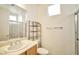 Clean bathroom featuring a toilet, vanity, glass enclosed shower, and shelving unit at 2585 Portsmouth Creek Ave, Henderson, NV 89052