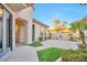 Charming courtyard with tiled patio, lush greenery, and manicured landscaping at 2585 Portsmouth Creek Ave, Henderson, NV 89052
