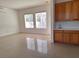 Inviting living room with large windows, tile flooring, and a convenient wet bar area at 2585 Portsmouth Creek Ave, Henderson, NV 89052