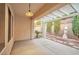 Covered patio area featuring a ceiling light, textured concrete, and privacy landscaping at 2585 Portsmouth Creek Ave, Henderson, NV 89052