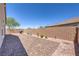 The brick-paved backyard features a grill, greenery, and ample space for entertaining at 326 Zenith Crest St, Henderson, NV 89015