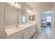Stylish bathroom with double sink vanity and view into the primary bedroom at 326 Zenith Crest St, Henderson, NV 89015
