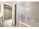 Clean white bathroom featuring a shower-tub, tile surround, and brushed-nickel plumbing fixtures at 326 Zenith Crest St, Henderson, NV 89015