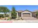 Charming single-story home with a desert landscape, paver driveway, and a two car garage at 326 Zenith Crest St, Henderson, NV 89015
