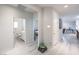 Bright hallway with wood floors and white walls, with view to bathroom and bedroom at 326 Zenith Crest St, Henderson, NV 89015