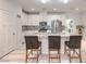 Well-lit kitchen with stainless steel appliances, island seating, and modern finishes at 326 Zenith Crest St, Henderson, NV 89015