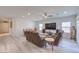 Open-concept living and dining area with light wood floors and a modern ceiling fan at 326 Zenith Crest St, Henderson, NV 89015