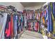 Spacious walk-in closet with ample storage and organization, filled with clothing at 326 Zenith Crest St, Henderson, NV 89015