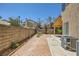 Backyard featuring an exposed aggregate patio, brick walls and desert landscaping at 333 Abbington St, Henderson, NV 89074
