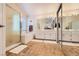 Bright bathroom featuring double sinks, shower, separate bathtub and a large mirror at 333 Abbington St, Henderson, NV 89074