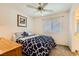 Bedroom with ceiling fan, window with blinders, and view of the bathroom at 333 Abbington St, Henderson, NV 89074
