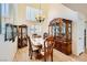 Formal dining room featuring tile flooring, a large window, and beautiful wood furniture including a china cabinet at 333 Abbington St, Henderson, NV 89074
