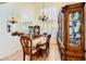 Formal dining room featuring tile flooring, a large window, mirrored accents, and beautiful wood furniture at 333 Abbington St, Henderson, NV 89074