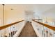 Second floor hallway with wood railing and carpeting leading to various rooms, lit by inset lighting at 333 Abbington St, Henderson, NV 89074