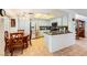 Open kitchen with light colored cabinets, granite countertops, stainless steel appliances, and tile flooring at 333 Abbington St, Henderson, NV 89074